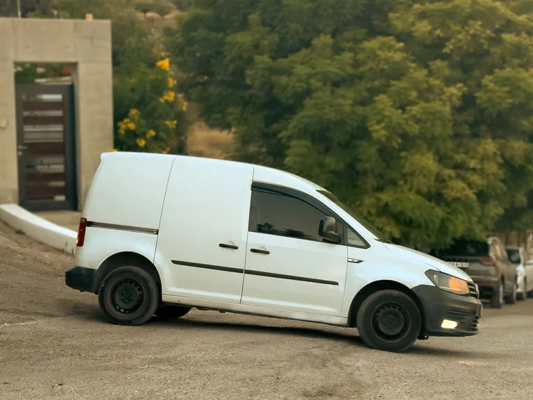 The Pet Lodge van at the gates with its side door open and a handler alongside
